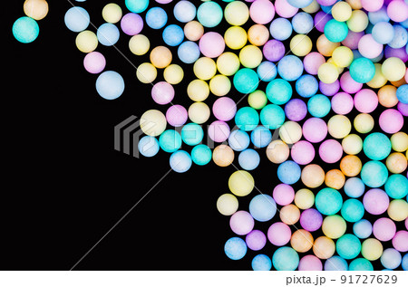 Foam beads of various colors brightly colored on black color background Foam beads of various colors brightly colored on black color background 91727629