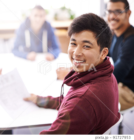 Meetings keep us on the same page. Portrait of a happy young man sitting in a meeting with his colleagues. Meetings keep us on the same page. Portrait of a happy young man sitting in a meeting with his colleagues. 91727953