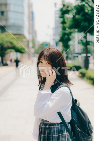 制服姿の女子高生と街並み 91728382