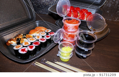 Set of delicious sushi rolls with wassabi and ginger in a box. Japanese food. Set of delicious sushi rolls with wassabi and ginger in a box. Japanese food. 91731209