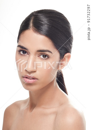 Shes serious about beauty care. Studio portrait of a beautiful young woman isolated on white gazing seriously at the camera. 91732297