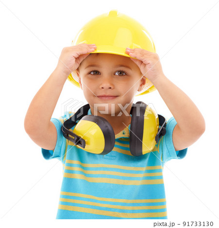 Bring on the noise. Studio shot of a cute young boy pretending to be a construction worker. 91733130