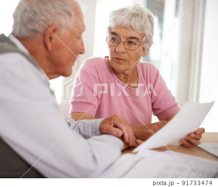 Taking time to discuss important matters. Shot of two elderly people discussing a document. Taking time to discuss important matters. Shot of two elderly people discussing a document. 91733474