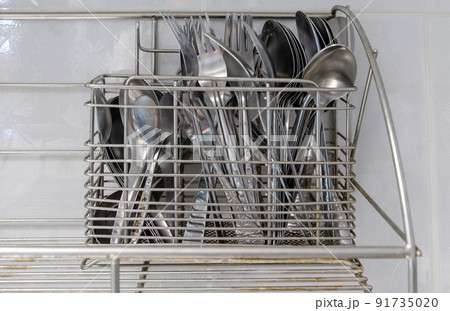 The metal cutlery stands for keeping the silverware near the white wall. 91735020