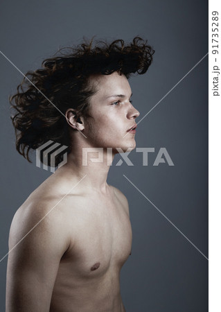 Easy fashion. Studio shot of a handsome young man posing against a gray background. Easy fashion. Studio shot of a handsome young man posing against a gray background. 91735289