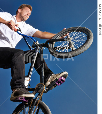 Practicing for the x games. Cropped shot of a teenage boy riding a BMX at a skatepark. 91735449