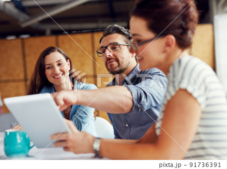 Making tomorrows success today. Shot of a group of coworkers having a meeting in an open plan office. 91736391