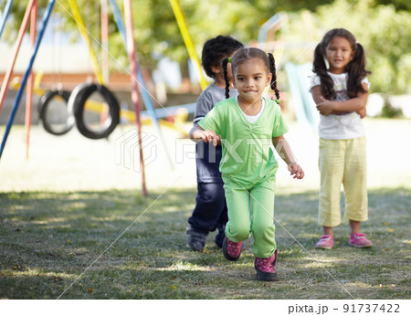 Childhood fun with friends. Some pre-school children playing in a local playground. Childhood fun with friends. Some pre-school children playing in a local playground. 91737422