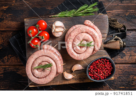 Bavarian Raw spiral sausages on a wooden board. Wooden background. Top view Bavarian Raw spiral sausages on a wooden board. Wooden background. Top view 91741851