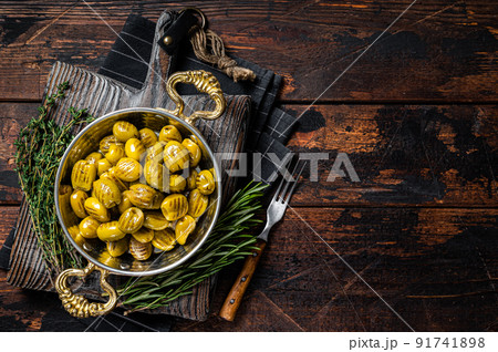 Turkish Grilled olives with olive oil and herbs in pan. Wooden background. Top view. Copy space Turkish Grilled olives with olive oil and herbs in pan. Wooden background. Top view. Copy space 91741898