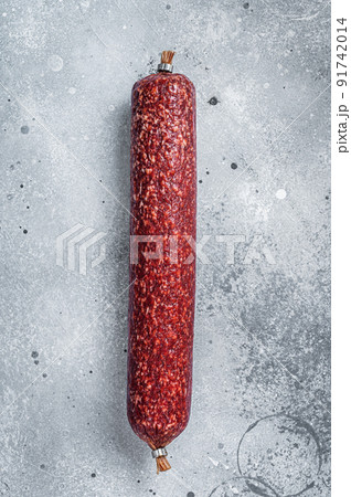 Dry salami sausage. Gray background. Top view Dry salami sausage. Gray background. Top view 91742014
