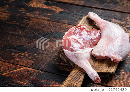 Uncooked Raw duck legs, Poultry meat on a wooden board. Wooden background. Top view. Copy space 91742429