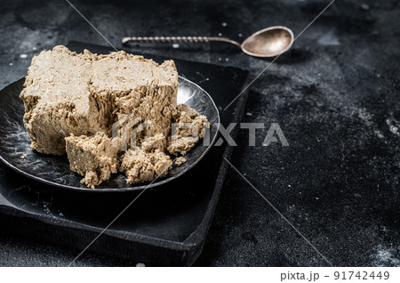 Homemade sunflower halva with honey. Black background. Top view. Copy space 91742449