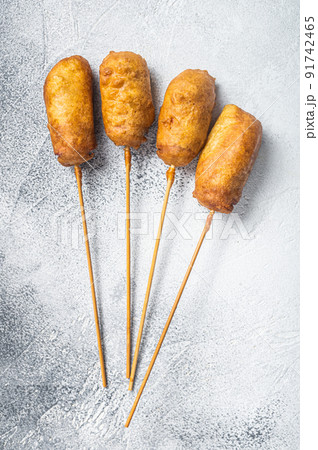 Homemade deep fried corn dogs. White background. Top view Homemade deep fried corn dogs. White background. Top view 91742465
