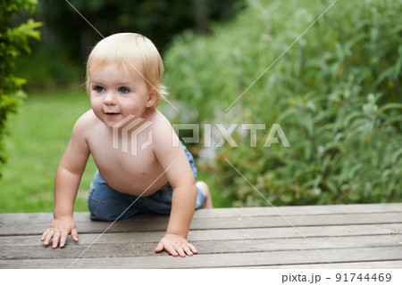 Hes a curious baby. A baby boy crawling on the stoop in the backyard. Hes a curious baby. A baby boy crawling on the stoop in the backyard. 91744469
