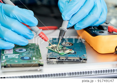 Technician repairing inside of mobile phone by soldering iron. Integrated Circuit. the concept of data, hardware, technology. 91749147