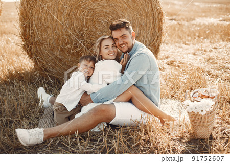 Family playing with baby son in wheat field on sunset. The concept of summer holiday. Family spending time together on nature. 91752607