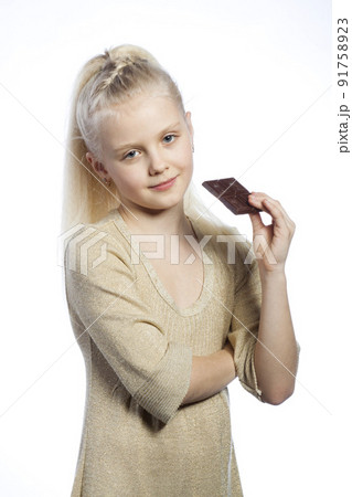 Beautiful girl eating chocolate. Beautiful girl eating chocolate. 91758923