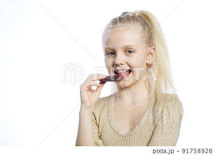 Beautiful girl eating chocolate. Beautiful girl eating chocolate. 91758926