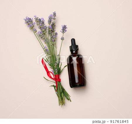 Glass brown bottle with a pipette and a bouquet of lavender Glass brown bottle with a pipette and a bouquet of lavender 91761845