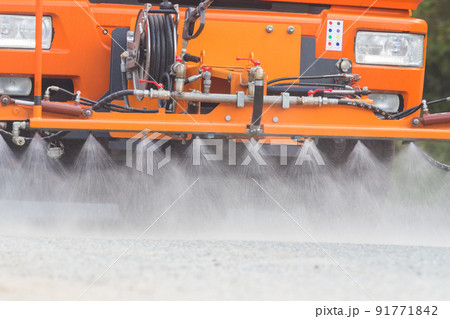 Big orange machine clears the asphalt with directed water streams Big orange machine clears the asphalt with directed water streams 91771842