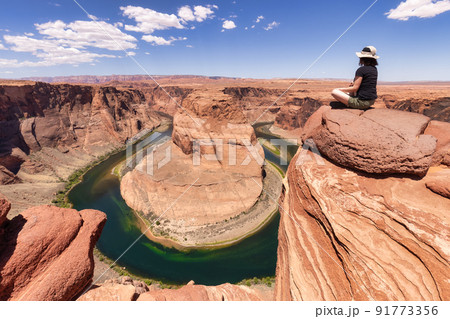 Adventurous Caucasian Woman at Horseshoe Bend in Page, Arizona, United States. Adventurous Caucasian Woman at Horseshoe Bend in Page, Arizona, United States. 91773356