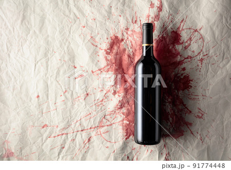 Bottle of red wine on a background with stains of wine. Bottle of red wine on a background with stains of wine. 91774448