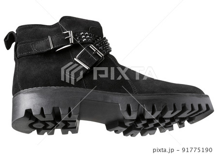 Suede black boot with strap and buckle, sole with deep tread, on a white background, bottom view Suede black boot with strap and buckle, sole with deep tread, on a white background, bottom view 91775190