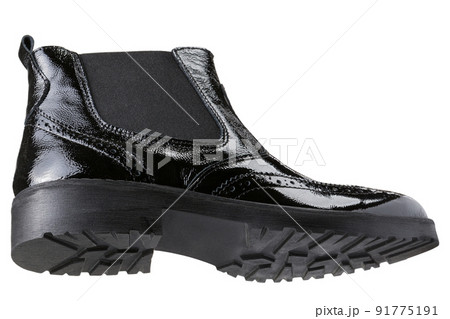 Women's black leather patent boot, sole with tread, on a white background, bottom view Women's black leather patent boot, sole with tread, on a white background, bottom view 91775191