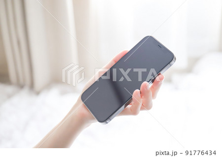 スマホを持つ手元　画面 91776434