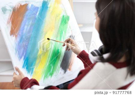 Female artist painting on canvas, Artist studio interior, Draw with watercolor, Drawing supplies , Painting and creativity, Use a brush to draw a pattern by stripes, Artwork, Using Paint Brush. Female artist painting on canvas, Artist studio interior, Draw with watercolor, Drawing supplies , Painting and creativity, Use a brush to draw a pattern by stripes, Artwork, Using Paint Brush. 91777768