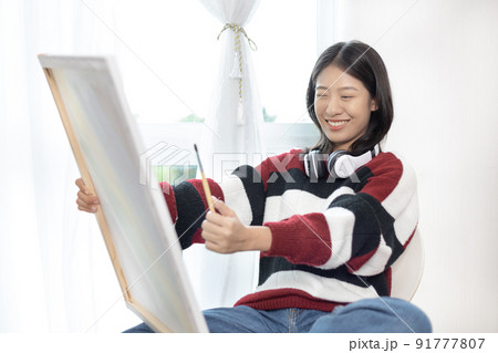 Female artist painting on canvas, Artist studio interior, Draw with watercolor, Drawing supplies , Painting and creativity, Use a brush to draw a pattern by stripes, Artwork, Using Paint Brush. 91777807