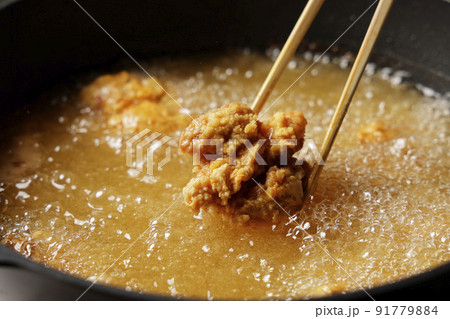 油で揚げている美味しそうな鶏の唐揚げ 油で揚げている美味しそうな鶏の唐揚げ 91779884