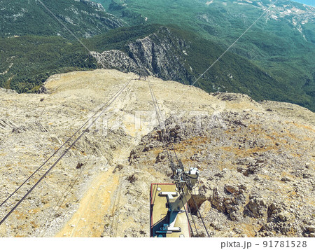 cable car on the mountain. observation deck on a mountain with grass and sand. sandstone texture. mountain with greenery cable car on the mountain. observation deck on a mountain with grass and sand. sandstone texture. mountain with greenery 91781528