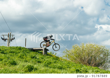 Mountain biker is jumping from the drop Mountain biker is jumping from the drop 91787889
