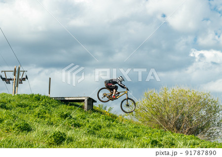 Mountain biker is jumping from the drop 91787890
