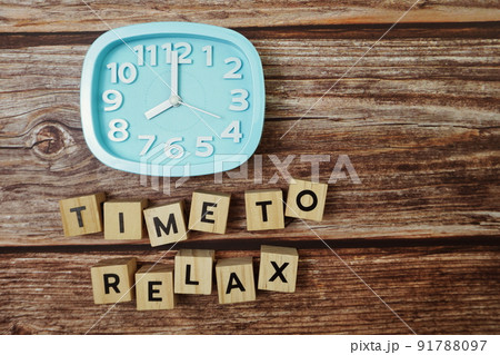Time To Relax alphabet letter with alarm clock on wooden background 91788097