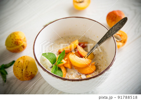 Healthy breakfast of apricot oatmeal with fresh fruit Healthy breakfast of apricot oatmeal with fresh fruit 91788518