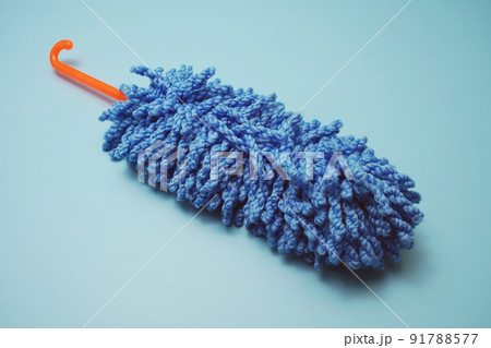 Handle microfiber duster isolate on blue background Handle microfiber duster isolate on blue background 91788577