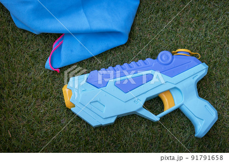 Water gun on the grass summer game Water gun on the grass summer game 91791658