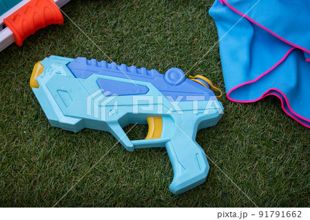 Water gun on the grass summer game Water gun on the grass summer game 91791662