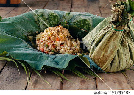 Cambodian Food Takeaway Wrapped in Eco-friendly Lotus Leaf Packaging Cambodian Food Takeaway Wrapped in Eco-friendly Lotus Leaf Packaging 91795403