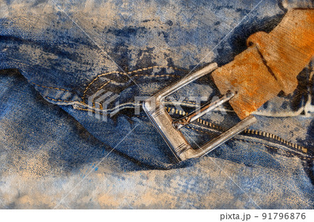 Removed blue jeans. Rubbed casual pants with brown leather belt. Silver shiny buckle. Close-up. Digital watercolor painting 91796876