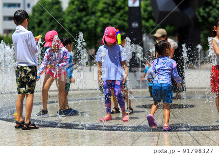 真夏の噴水で水遊びを満喫する子どもたち 91798327