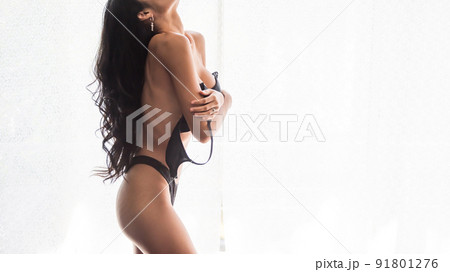 Closeup Asian woman take off black bra by white curtain 91801276