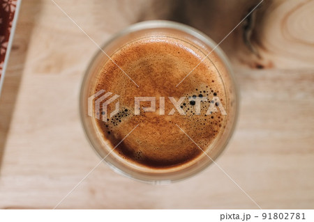 Two espresso coffee and eclair on wooden table in the morning. 91802781