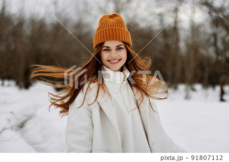 woman in winter clothes in a hat fun winter landscape Lifestyle woman in winter clothes in a hat fun winter landscape Lifestyle 91807112