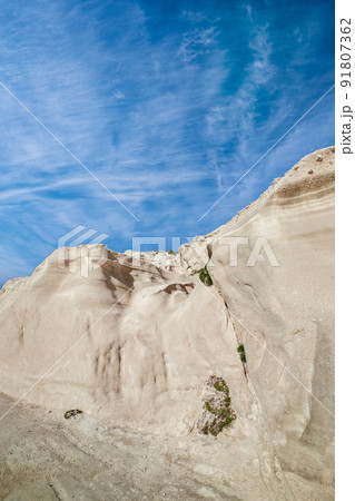 White rocks of Sarakiniko beach, Aegean sea, Milos island , Greece. No people, empty cliffs, summer sunshine, lunar landscape, deep blue sky, clouds 91807362