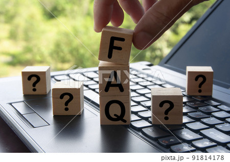 Hand holding FAQ word on wooden block on top of laptop with blurred nature background. Information concept Hand holding FAQ word on wooden block on top of laptop with blurred nature background. Information concept 91814178