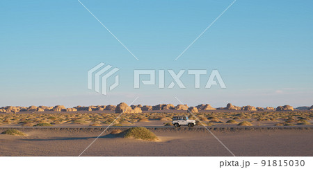 vehicle on the road in national geological park in dunhuang, gansu province, china 91815030